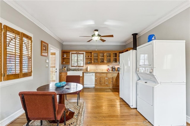 698 Bellemeade Ave NW, Atlanta, GA 30318 - kitchen featuring stacked washer / drying machine, white appliances, a ceiling fan, light wood-style floors, and brown cabinets