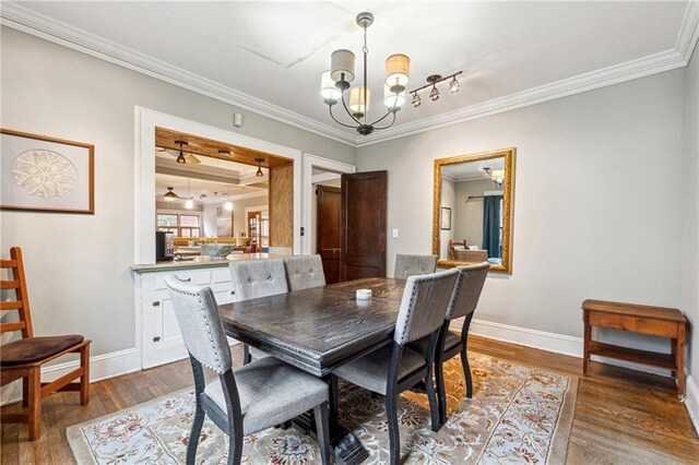 698 Bellemeade Ave NW, Atlanta, GA 30318 - dining space with a chandelier, ornamental molding, wood finished floors, and baseboards