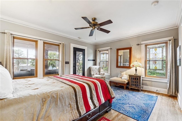 698 Bellemeade Ave NW, Atlanta, GA 30318 - bedroom with multiple windows, baseboards, wood finished floors, crown molding, and ceiling fan