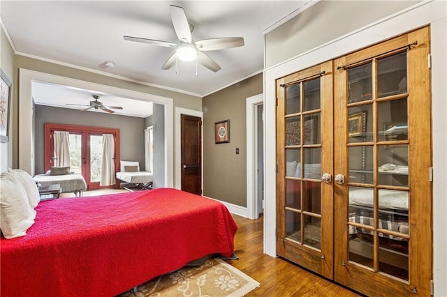 698 Bellemeade Ave NW, Atlanta, GA 30318 - bedroom with french doors, wood finished floors, crown molding, a ceiling fan, and baseboards