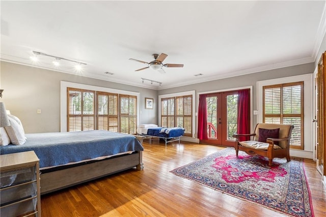 698 Bellemeade Ave NW, Atlanta, GA 30318 - bedroom with access to exterior, multiple windows, wood finished floors, ornamental molding, and french doors