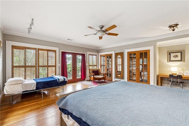 698 Bellemeade Ave NW, Atlanta, GA 30318 - bedroom featuring french doors, access to exterior, wood finished floors, ornamental molding, and track lighting