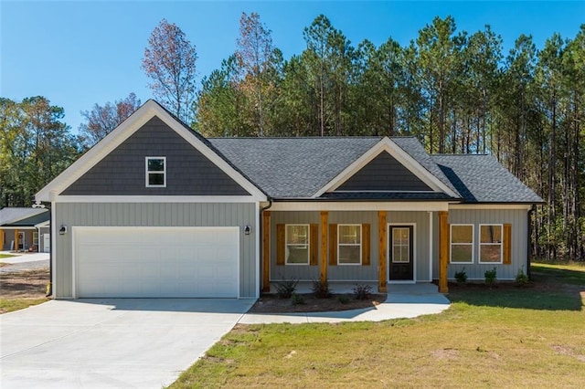 view of front of house with covered porch, concrete driveway, a front yard, and a shingled roof