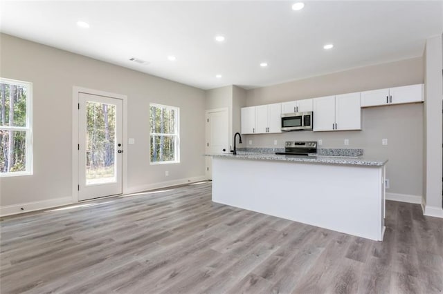 kitchen featuring a sink, appliances with stainless steel finishes, white cabinets, and recessed lighting