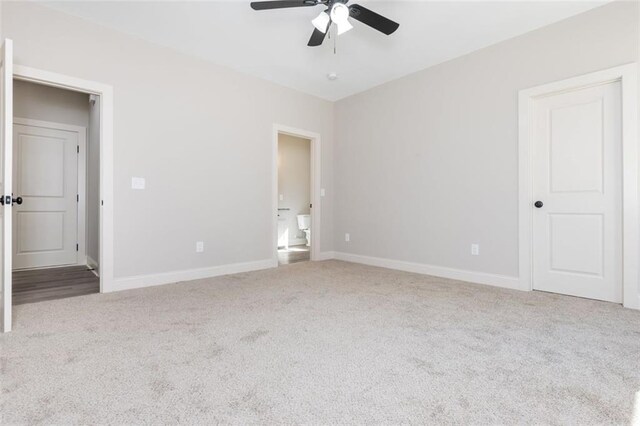 unfurnished bedroom with baseboards, carpet floors, and a ceiling fan