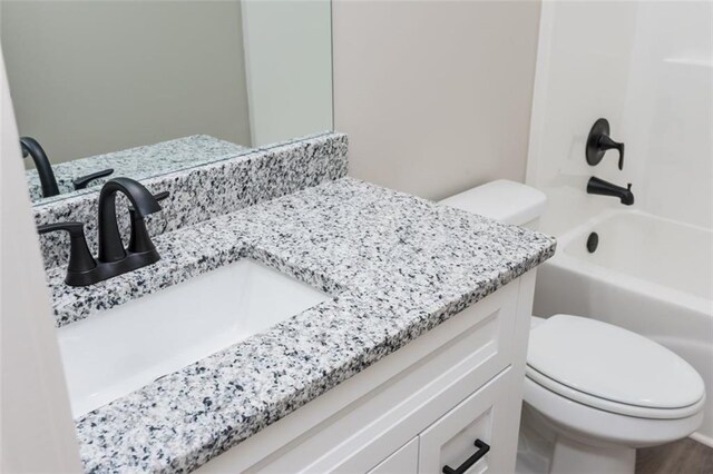 full bathroom featuring toilet, vanity, and shower / tub combination