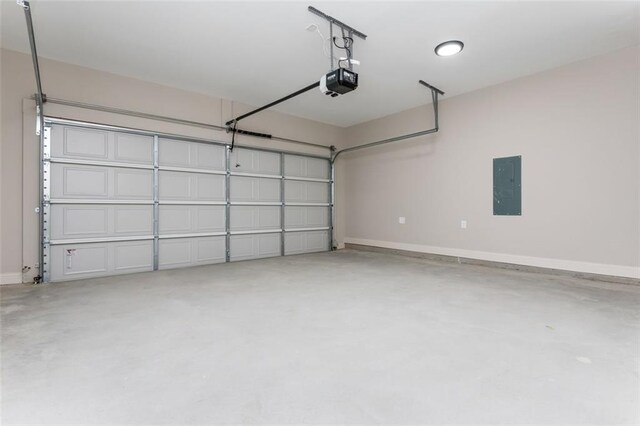 garage with electric panel, a garage door opener, and baseboards