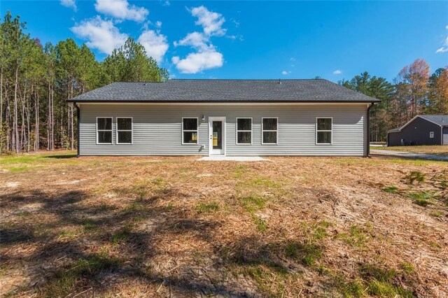 rear view of house with a yard