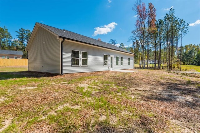 rear view of property featuring a yard