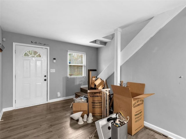 entryway featuring baseboards and wood finished floors