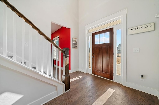 foyer entrance featuring dark hardwood / wood-style flooring and a wealth of natural light