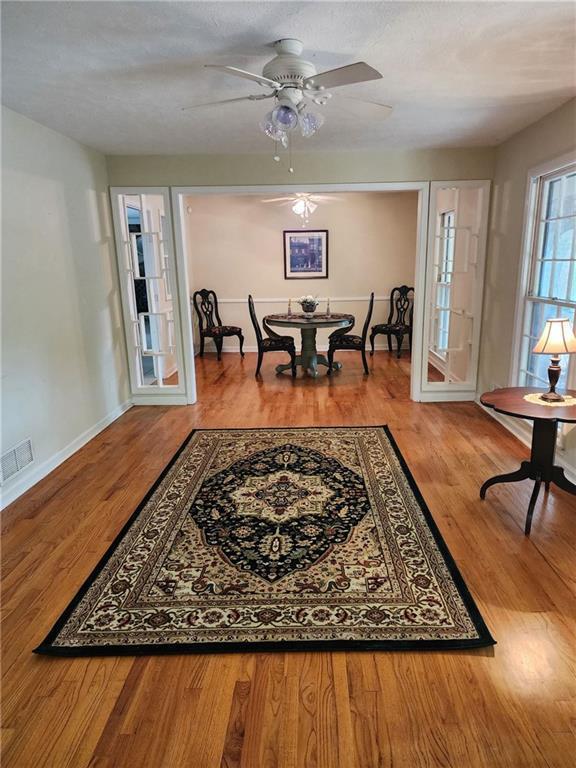 dining room with ceiling fan and hardwood / wood-style flooring