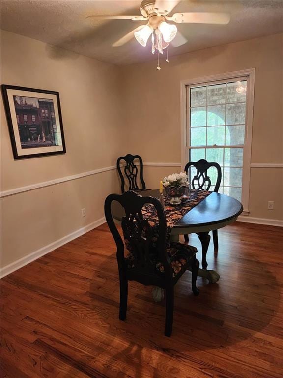 dining room with dark wood-type flooring and ceiling fan