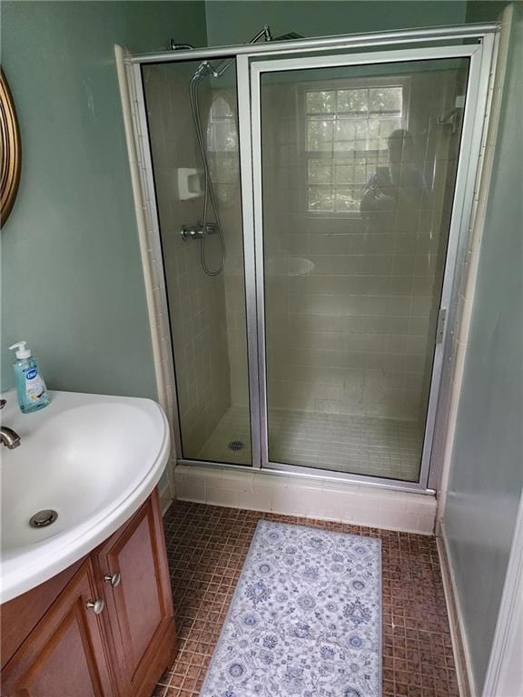 bathroom with vanity, an enclosed shower, and tile patterned floors