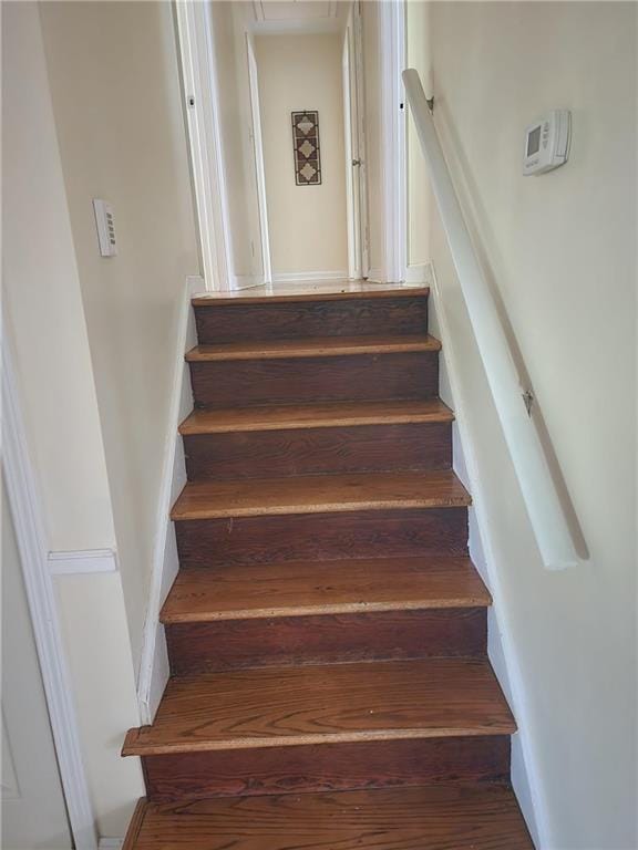 stairway featuring hardwood / wood-style floors