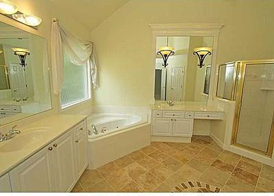 bathroom with separate shower and tub, tile flooring, and vanity