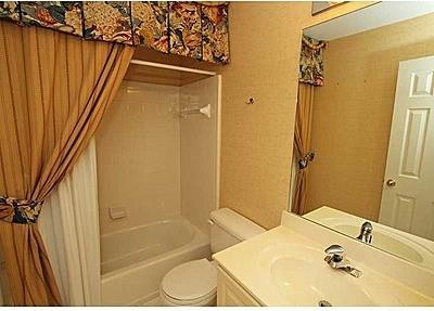 full bathroom featuring toilet, shower / tub combo, and vanity