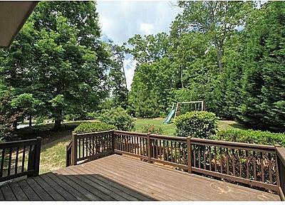 wooden terrace with a playground