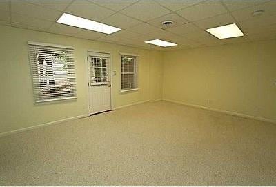 unfurnished room with carpet flooring and a drop ceiling