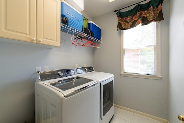 laundry room with cabinets, separate washer and dryer, and light tile floors