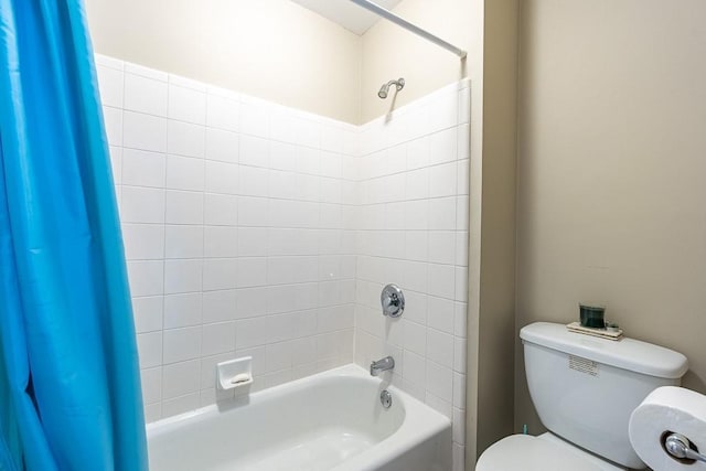 bathroom with shower / bath combo with shower curtain and toilet