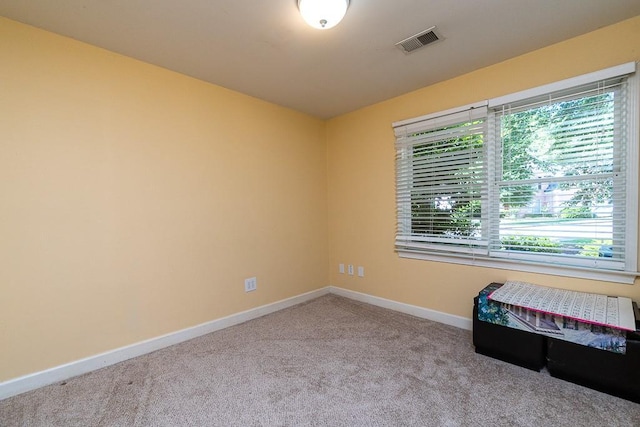 spare room featuring light colored carpet