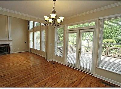 entryway featuring plenty of natural light, a notable chandelier, and dark wood-type flooring