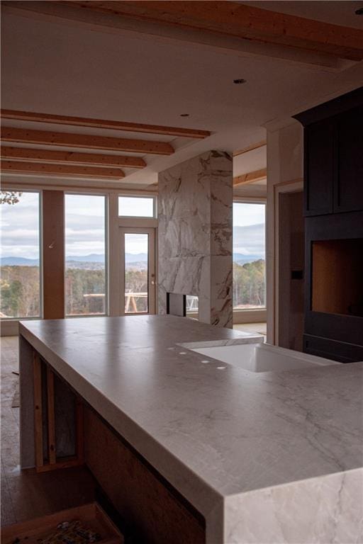 kitchen with beamed ceiling and a mountain view