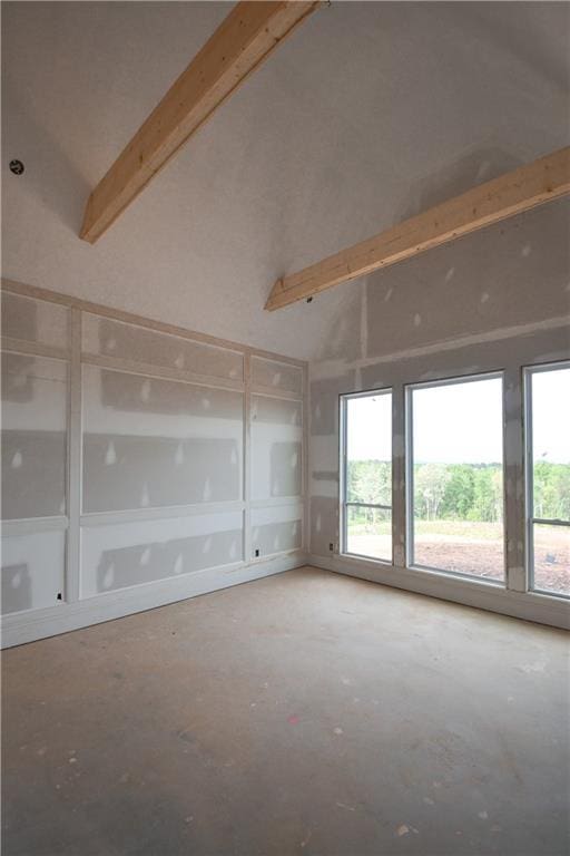 spare room featuring beamed ceiling and high vaulted ceiling