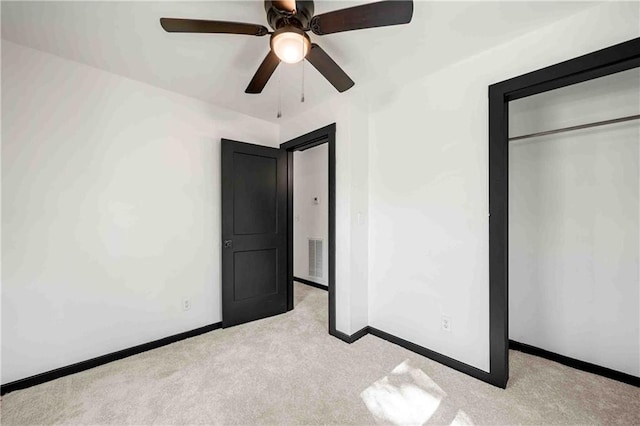 unfurnished bedroom featuring visible vents, baseboards, a closet, and carpet