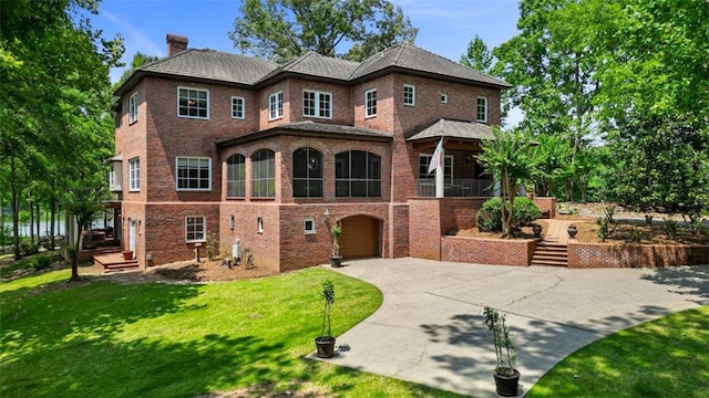 4043 Piedmont Lake Rd, Pine Mountain, GA 31822 - view of front of home with concrete driveway, brick siding, a garage, a chimney, and a front yard
