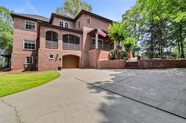 4043 Piedmont Lake Rd, Pine Mountain, GA 31822 - view of front of home featuring driveway, a garage, brick siding, stairs, and a front lawn