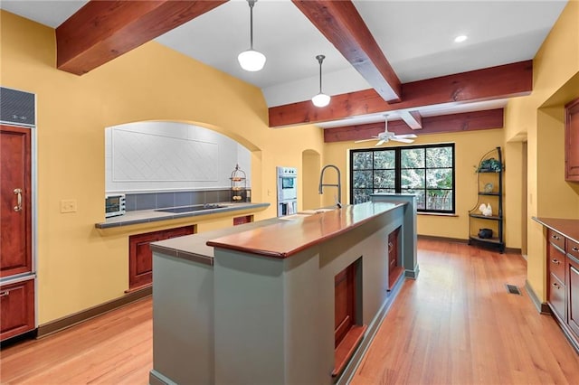 4043 Piedmont Lake Rd, Pine Mountain, GA 31822 - kitchen with beamed ceiling, black electric stovetop, light wood finished floors, a sink, and tasteful backsplash