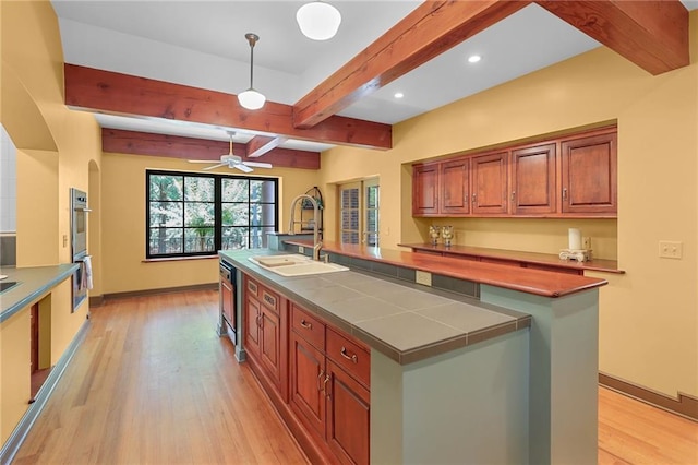 4043 Piedmont Lake Rd, Pine Mountain, GA 31822 - kitchen with a sink, light wood-style flooring, beam ceiling, an island with sink, and stainless steel double oven