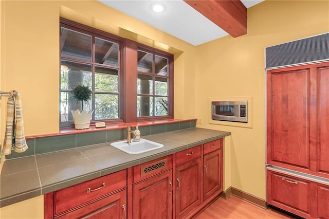 4043 Piedmont Lake Rd, Pine Mountain, GA 31822 - kitchen featuring a sink, paneled fridge, stainless steel microwave, tile countertops, and dark brown cabinets