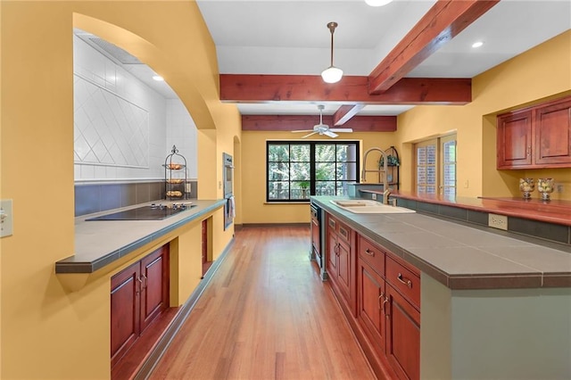 4043 Piedmont Lake Rd, Pine Mountain, GA 31822 - kitchen with black electric stovetop, a sink, light wood-style flooring, ceiling fan, and beamed ceiling