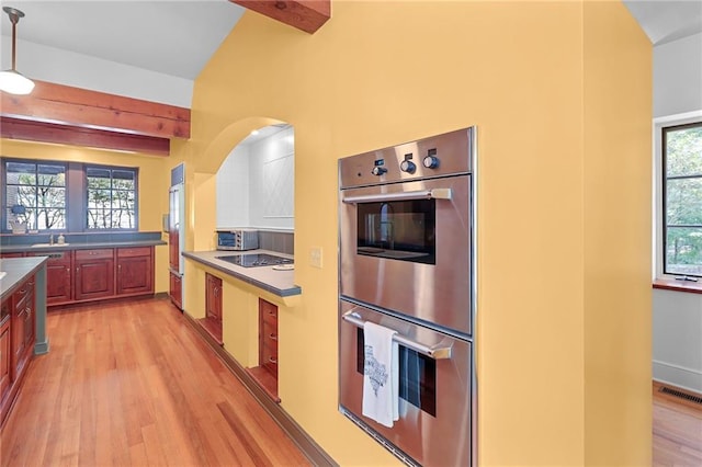 4043 Piedmont Lake Rd, Pine Mountain, GA 31822 - kitchen featuring appliances with stainless steel finishes, light wood-style floors, arched walkways, beamed ceiling, and pendant lighting