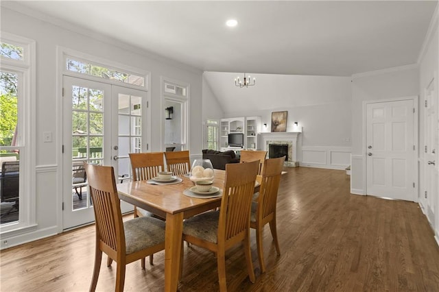 3260 Kingshouse Commons, Johns Creek, GA 30022 - dining space with crown molding, plenty of natural light, a chandelier, wood finished floors, and a decorative wall
