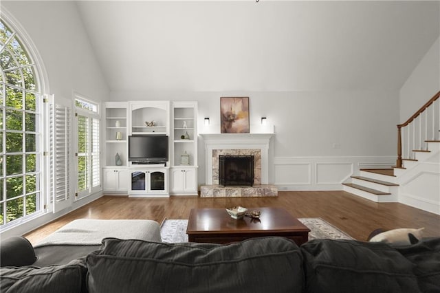 3260 Kingshouse Commons, Johns Creek, GA 30022 - living area with wood finished floors, high vaulted ceiling, stairs, a high end fireplace, and a wainscoted wall