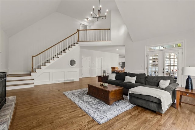3260 Kingshouse Commons, Johns Creek, GA 30022 - living area featuring high vaulted ceiling, stairs, a chandelier, wood finished floors, and wainscoting