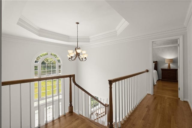 3260 Kingshouse Commons, Johns Creek, GA 30022 - corridor featuring a chandelier, an upstairs landing, a raised ceiling, wood finished floors, and crown molding