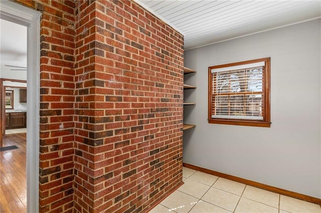 empty room with light tile patterned floors and baseboards