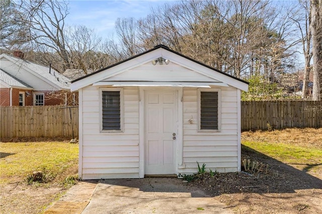 view of shed featuring fence