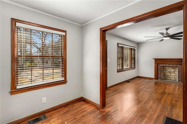 interior space with visible vents, a fireplace, and wood finished floors