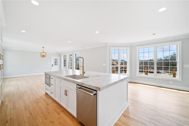 kitchen with sink, white cabinets, hanging light fixtures, a kitchen island with sink, and stainless steel dishwasher