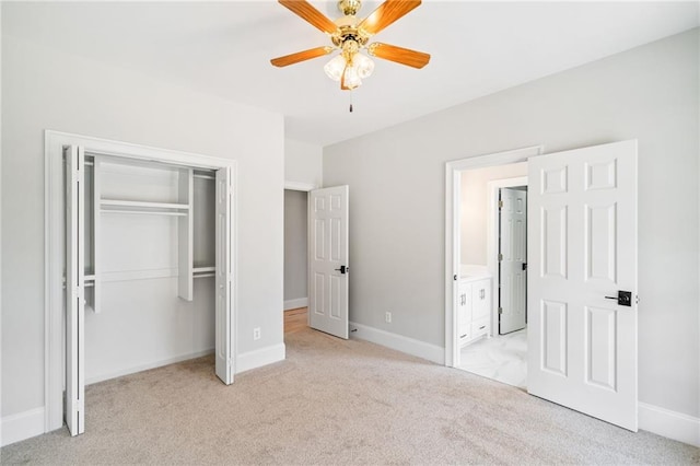 unfurnished bedroom with ceiling fan, light colored carpet, and a closet