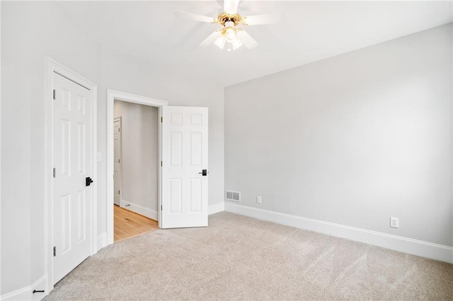 unfurnished bedroom with light carpet and ceiling fan