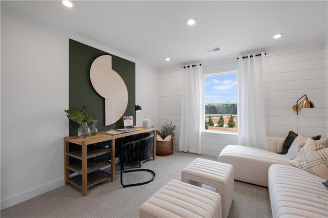 living room with crown molding and light colored carpet