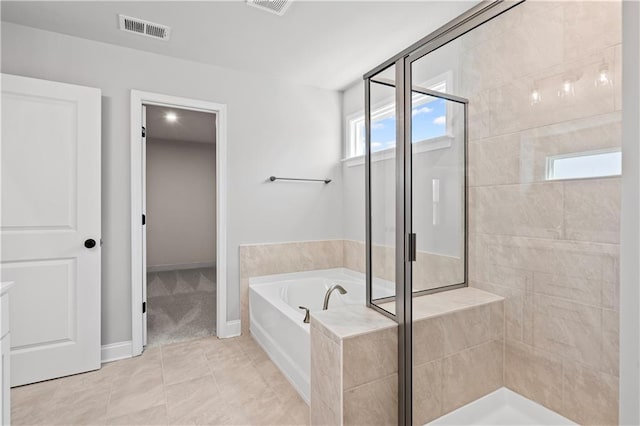 313 Foxglove Way, Mcdonough, GA 30253 - bathroom with a stall shower, a garden tub, baseboards, and visible vents