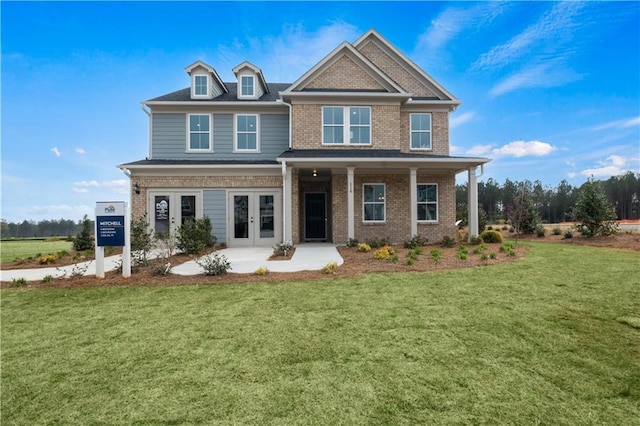 craftsman house with french doors and a front lawn